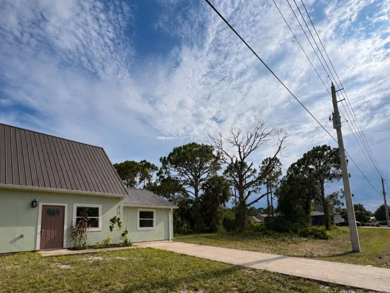 The same house with the tree gone and the roofline clear.